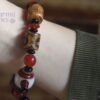 DB-25-002-03-scaled-1.jpg Brown Dzi Bead with Red Bead Ornaments