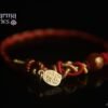 Red Tibetan-Style Braided Bracelet with a Golden Good-Luck Pendant