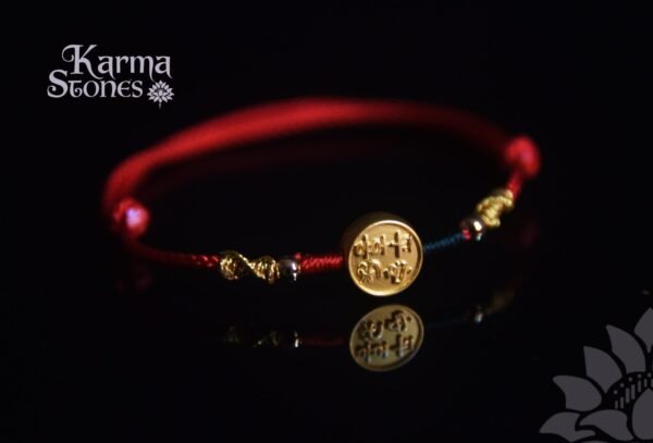 Red Tibetan-Style Braided Bracelet with a Golden "Peace and Joy" Charm
